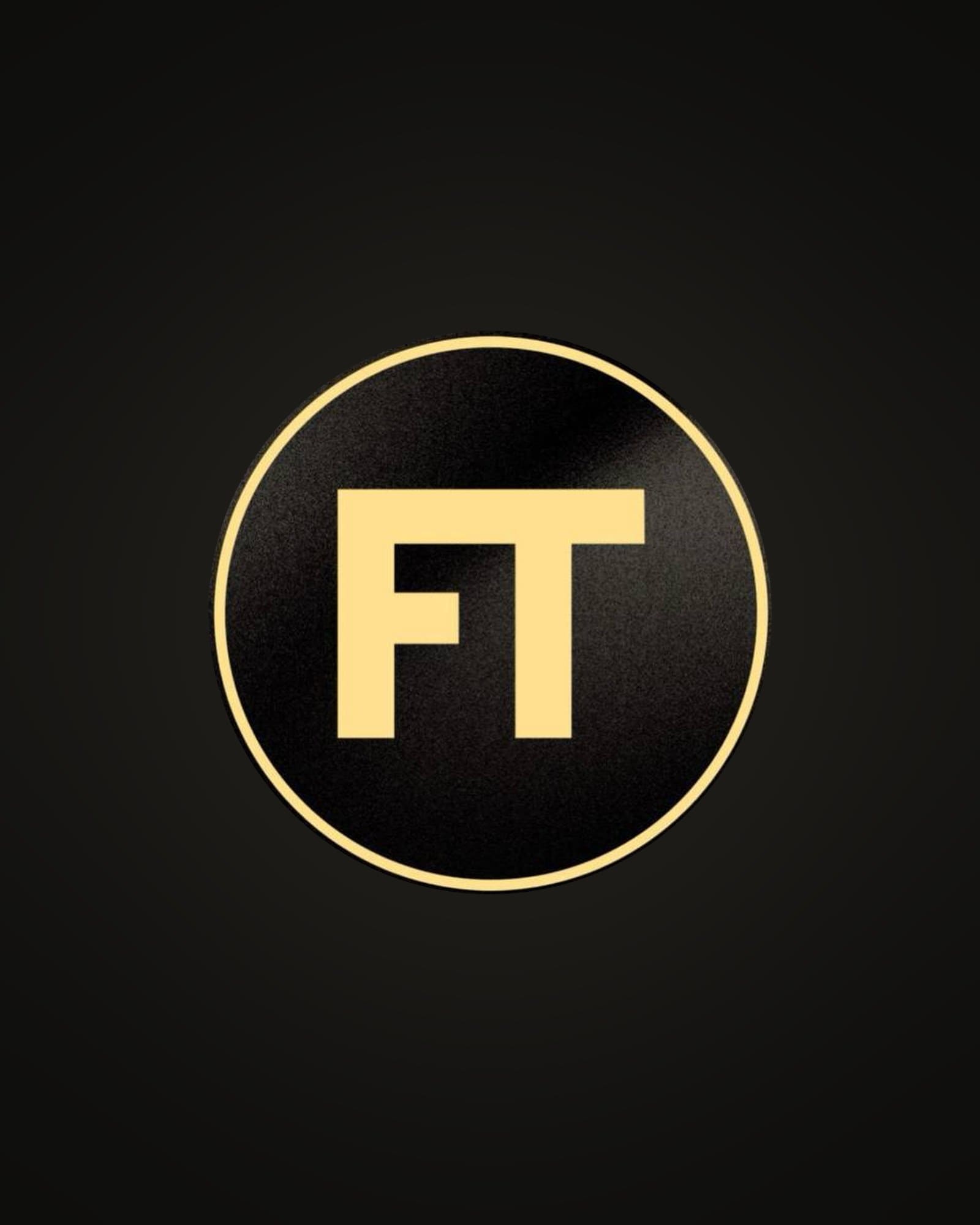 The FT Wallet emblem: gold letters FT inside a gold ring on black