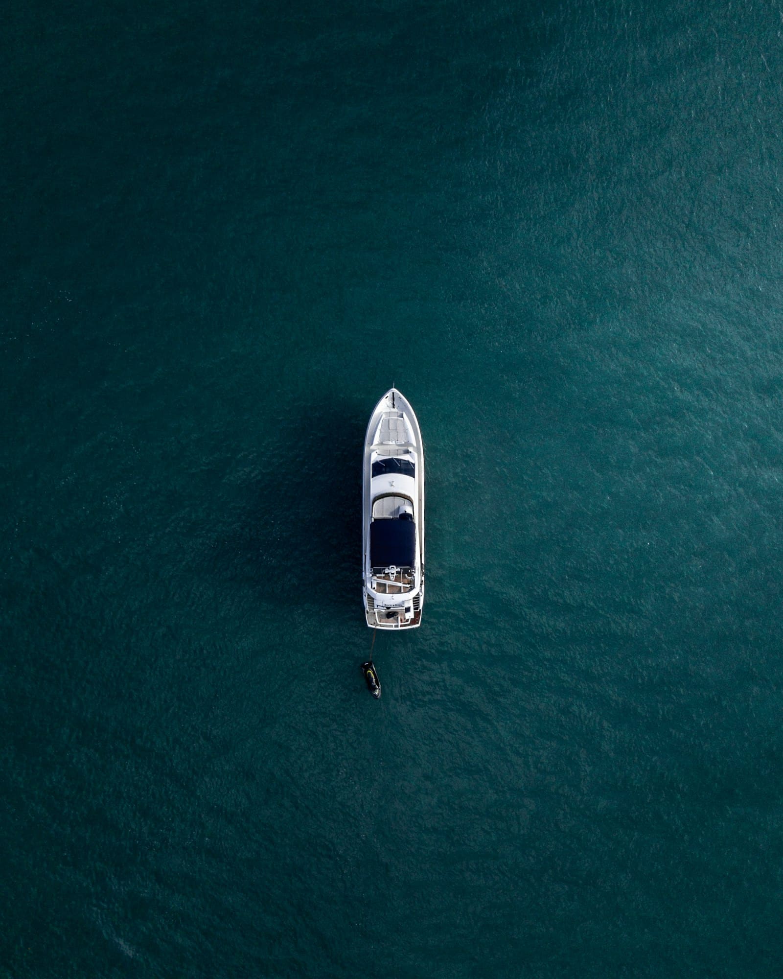 Aerial view of a yacht crossing deep blue water